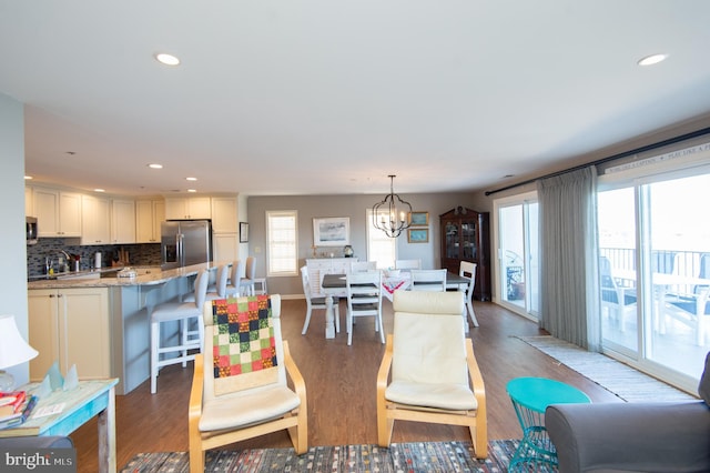 dining space with recessed lighting, baseboards, a chandelier, and light wood finished floors