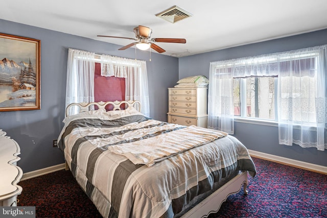 bedroom featuring baseboards, visible vents, and ceiling fan