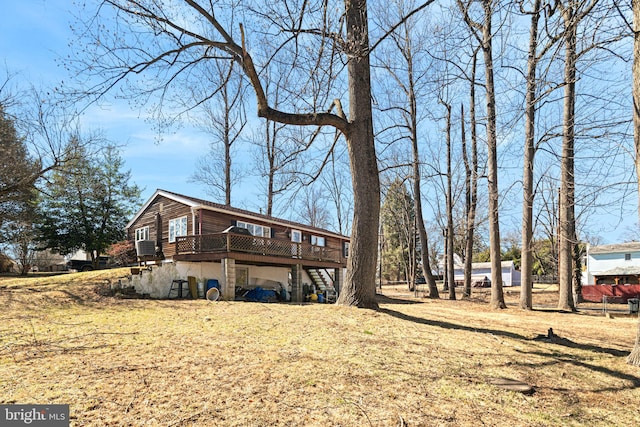 view of side of home featuring a deck and stairs