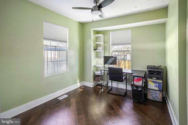 office featuring a wealth of natural light, visible vents, baseboards, and hardwood / wood-style floors