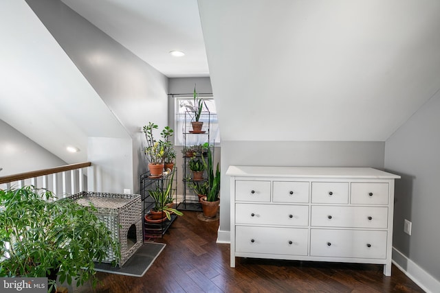 bonus room featuring baseboards, lofted ceiling, and dark wood finished floors