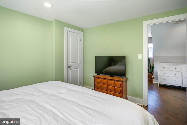 bedroom with dark wood finished floors, recessed lighting, and baseboards