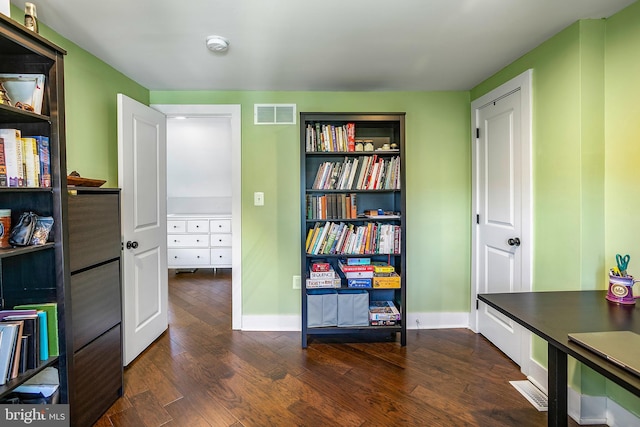 office area with visible vents, baseboards, and dark wood-style flooring