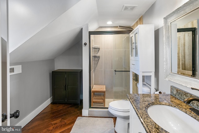 bathroom with visible vents, a shower stall, toilet, and wood finished floors