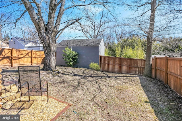 view of yard featuring an outdoor structure, a storage shed, and a fenced backyard