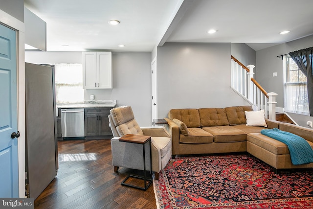 living room featuring recessed lighting, stairway, and dark wood-type flooring