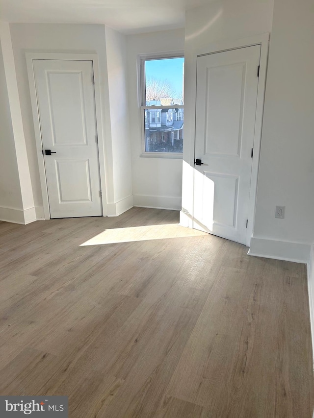 interior space with light wood-style flooring and baseboards