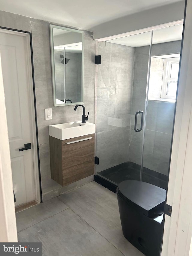 full bath with a shower stall and vanity