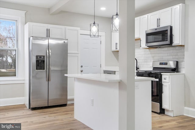 kitchen with white cabinetry, backsplash, light wood finished floors, and appliances with stainless steel finishes