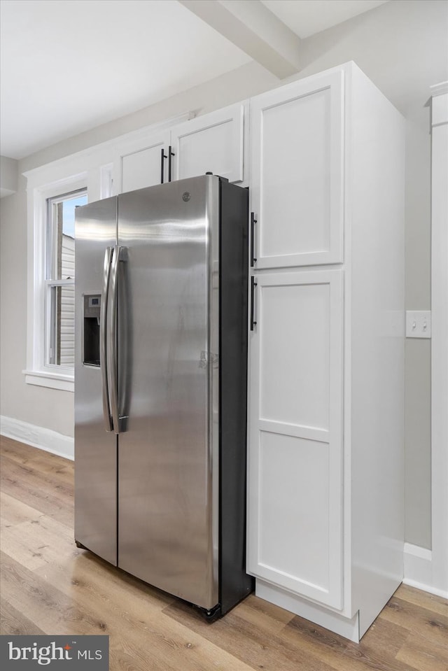 kitchen featuring light wood finished floors, white cabinetry, and stainless steel fridge with ice dispenser