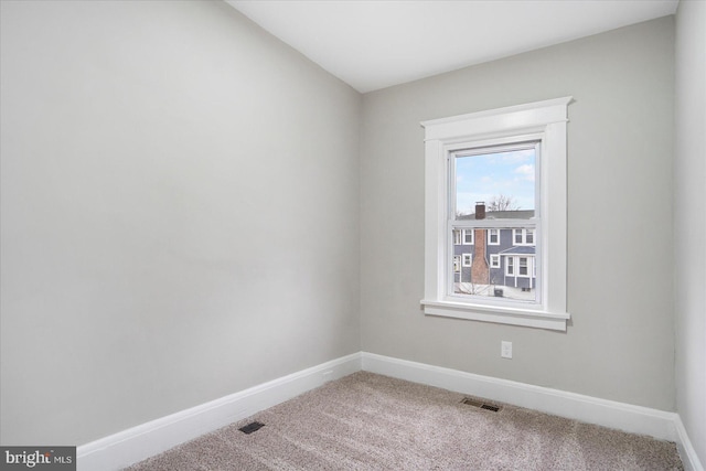 unfurnished room with visible vents, baseboards, and carpet floors