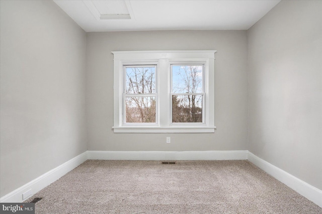 spare room featuring visible vents, baseboards, and carpet floors