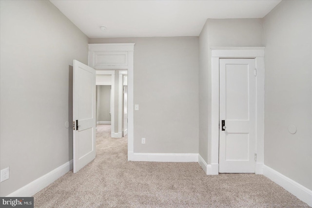 unfurnished bedroom with baseboards and carpet