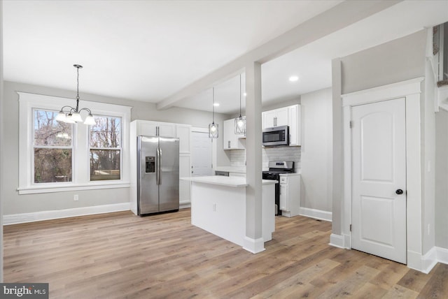 kitchen with tasteful backsplash, appliances with stainless steel finishes, white cabinetry, and light wood-type flooring