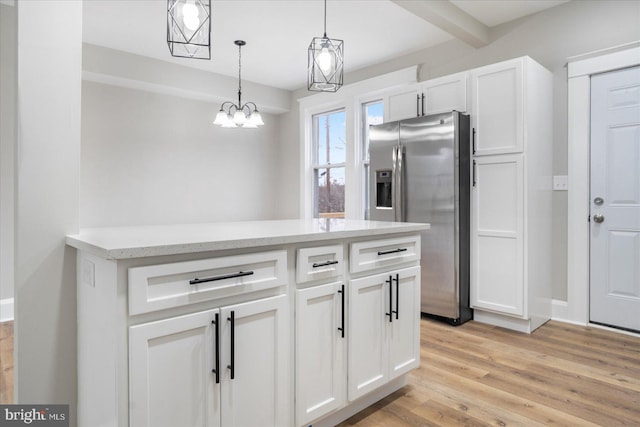 kitchen with decorative light fixtures, light wood-style flooring, stainless steel fridge with ice dispenser, and white cabinetry