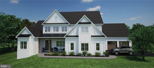 view of front facade featuring a front yard, an attached garage, and board and batten siding