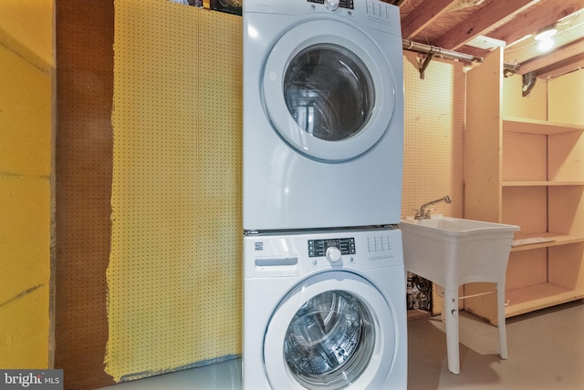 washroom with laundry area and stacked washer / drying machine