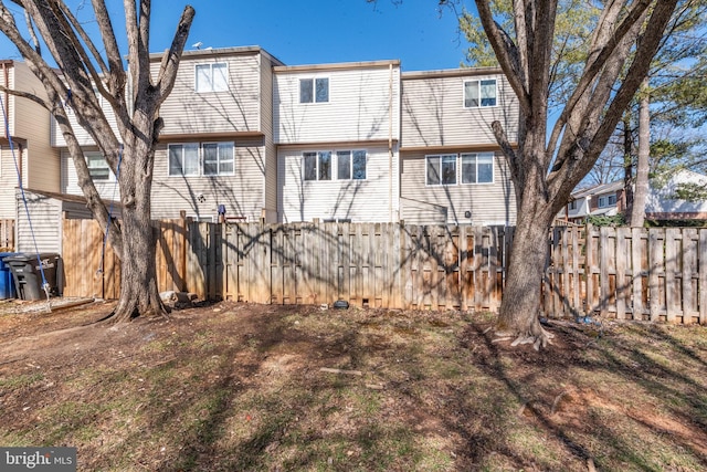 back of house with fence