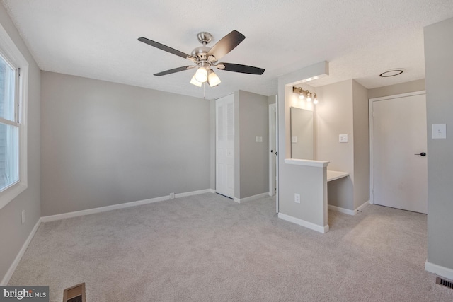 unfurnished bedroom with visible vents, a ceiling fan, a closet, carpet floors, and baseboards