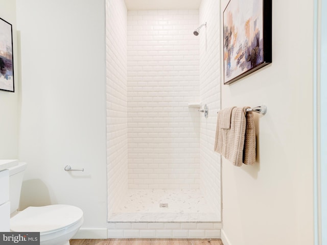 full bath featuring a shower stall, toilet, and baseboards