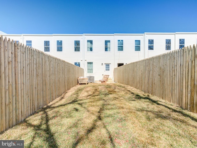 view of yard featuring central air condition unit and a fenced backyard