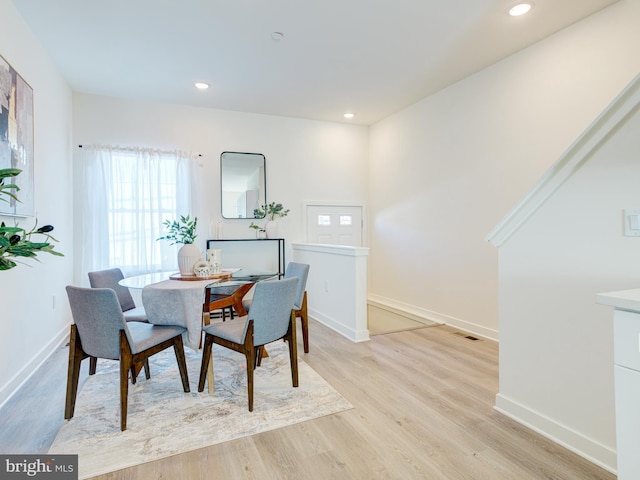 dining space with recessed lighting, baseboards, and light wood-style floors