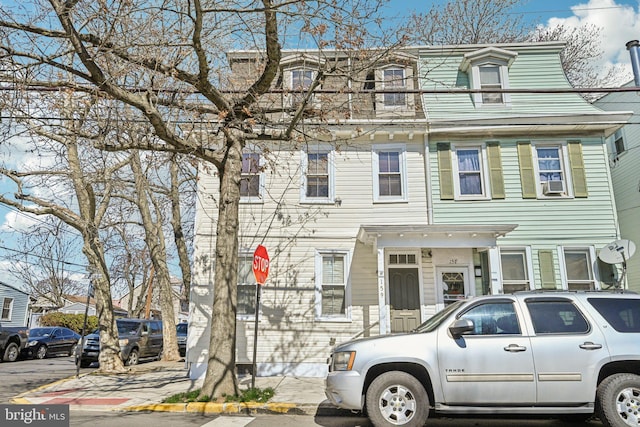 view of front facade with mansard roof