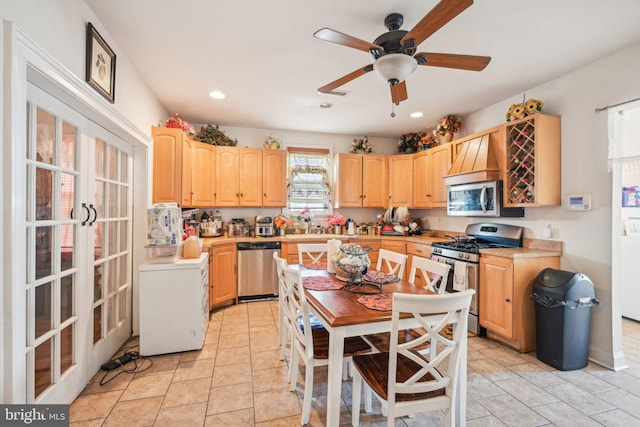 kitchen featuring light brown cabinetry, appliances with stainless steel finishes, washer / clothes dryer, and light countertops