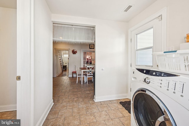 laundry area featuring visible vents, baseboards, washer / dryer, and laundry area