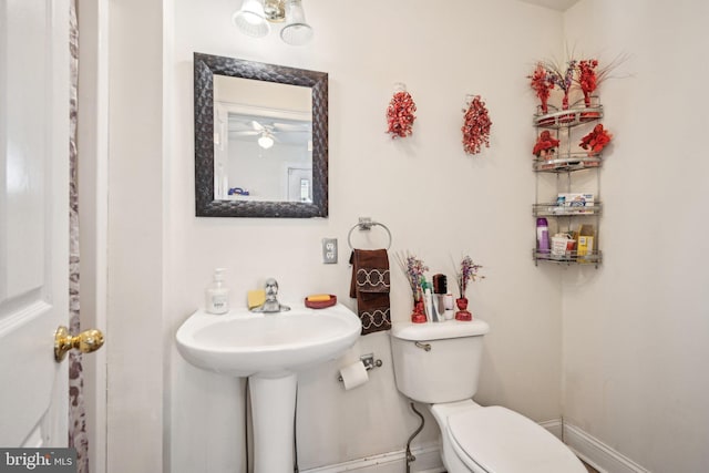 bathroom featuring toilet and baseboards