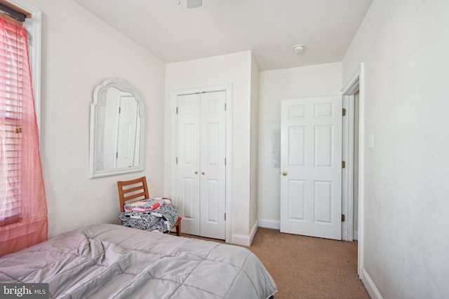 bedroom with a closet, baseboards, and carpet flooring