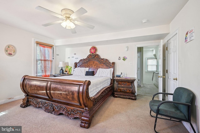 carpeted bedroom featuring baseboards and a ceiling fan