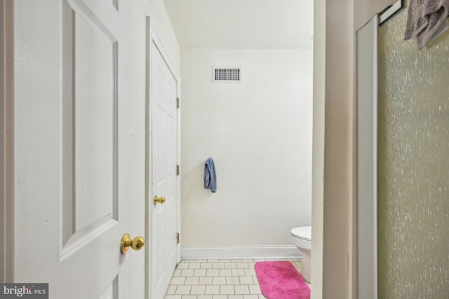 bathroom featuring tile patterned floors, visible vents, toilet, and baseboards