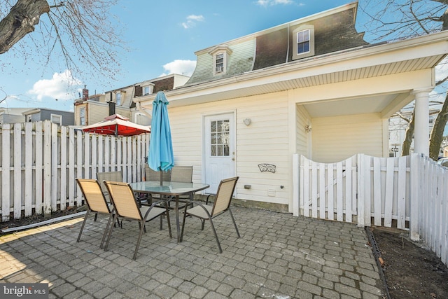 view of patio featuring outdoor dining space and fence