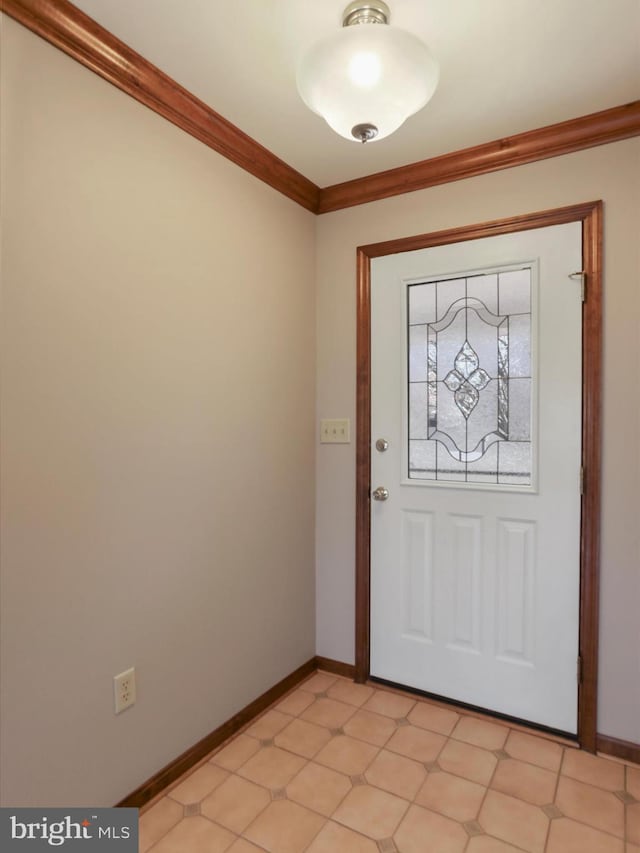 entryway featuring baseboards and ornamental molding