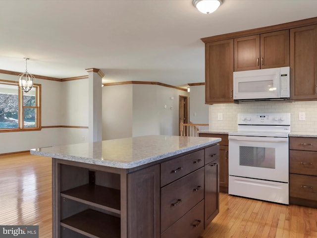 kitchen featuring white appliances, crown molding, light wood-type flooring, and backsplash