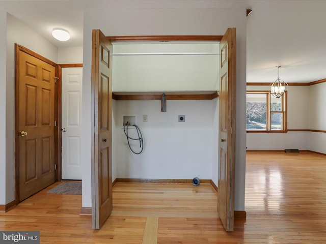 washroom featuring hookup for a washing machine, light wood-style floors, hookup for an electric dryer, and laundry area