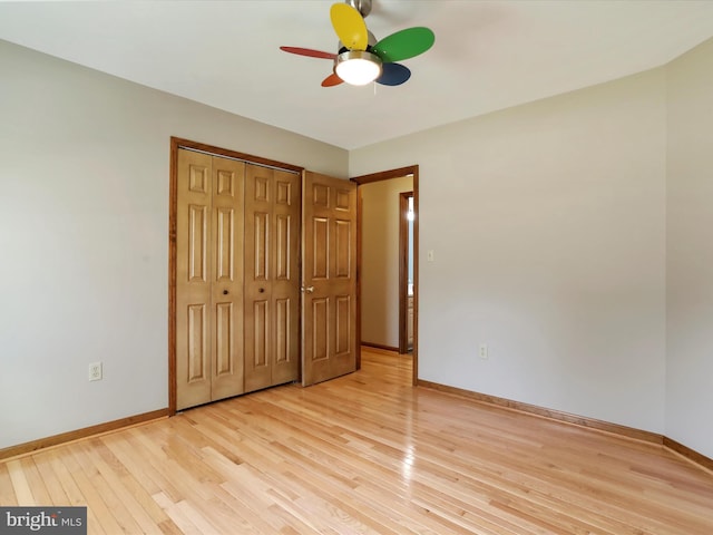 unfurnished bedroom featuring a closet, baseboards, and light wood-style floors