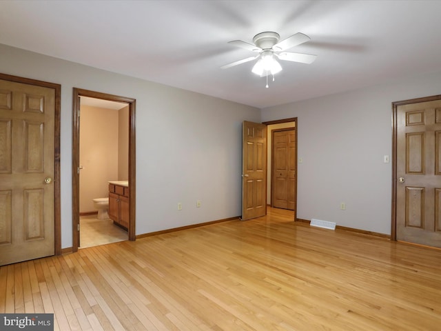 unfurnished bedroom featuring connected bathroom, visible vents, light wood-type flooring, and baseboards