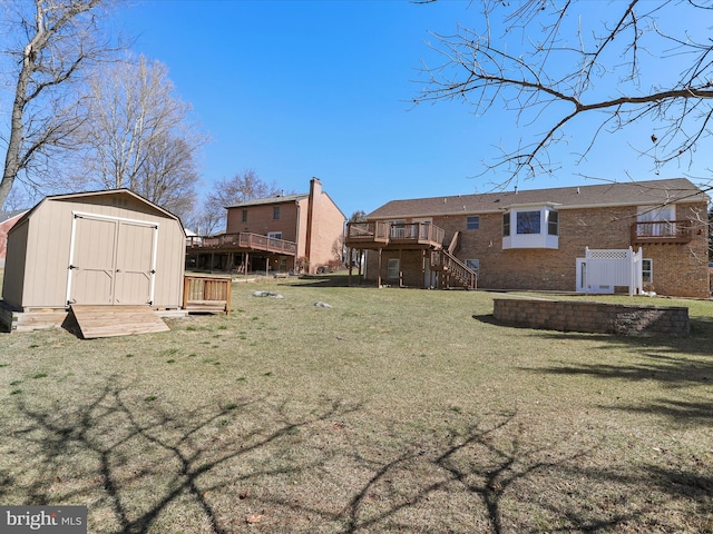 view of yard with an outbuilding, stairway, a storage unit, and a deck