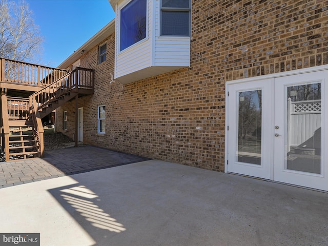 view of patio with french doors, a deck, and stairs