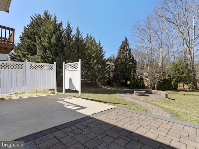 view of patio / terrace with fence and a fire pit