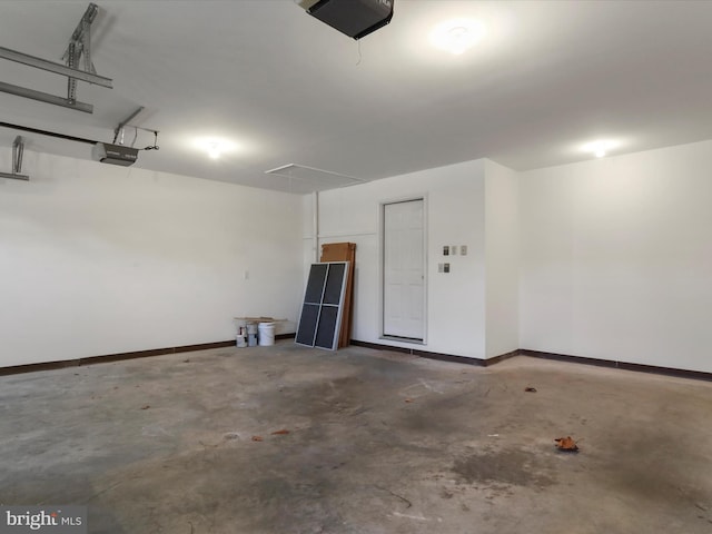 garage with baseboards and a garage door opener