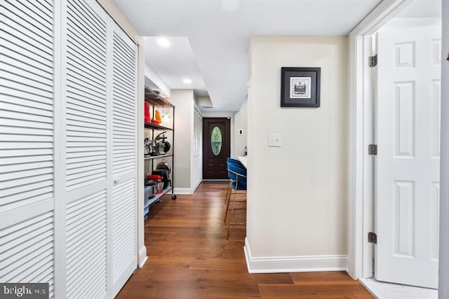 hallway with baseboards and dark wood-style floors