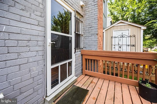 deck featuring an outdoor structure and a shed