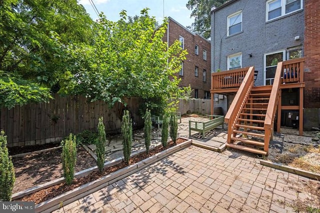 view of patio / terrace with stairway, a fenced backyard, and a wooden deck