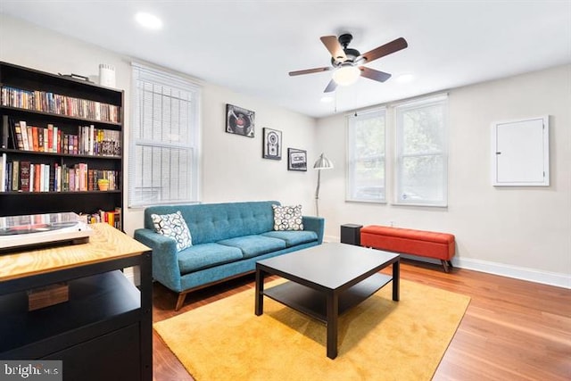 living room featuring recessed lighting, ceiling fan, baseboards, and wood finished floors