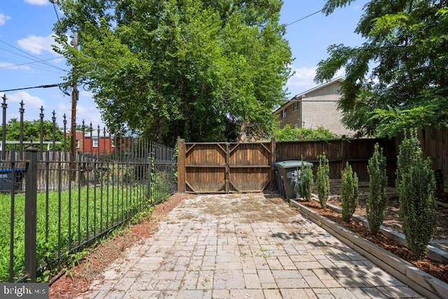 view of patio featuring a gate and fence