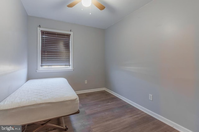 bedroom with a ceiling fan, wood finished floors, and baseboards