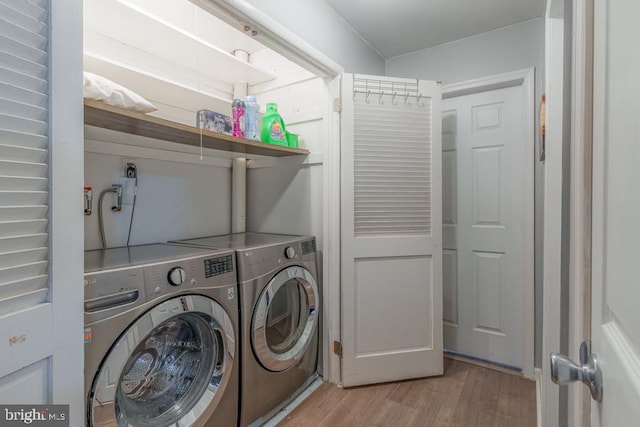 laundry room featuring laundry area, light wood-style flooring, and independent washer and dryer